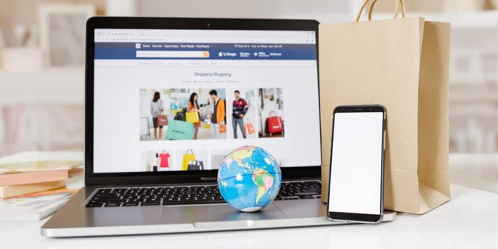 Laptop computer, smartphone, shopping bag, globe